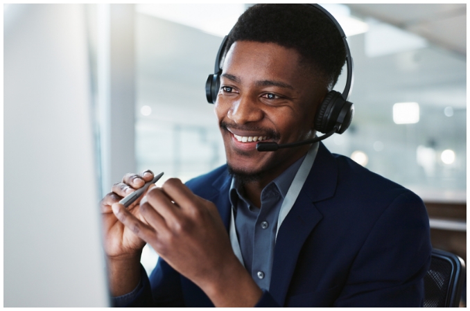 Man in call centre delivering great customer service