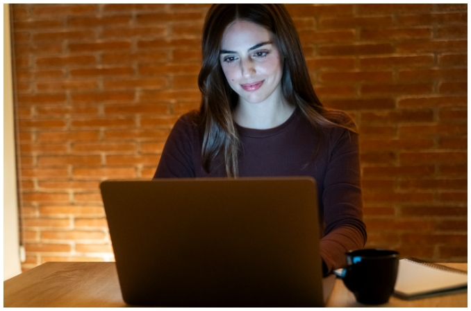 woman smiling at laptop